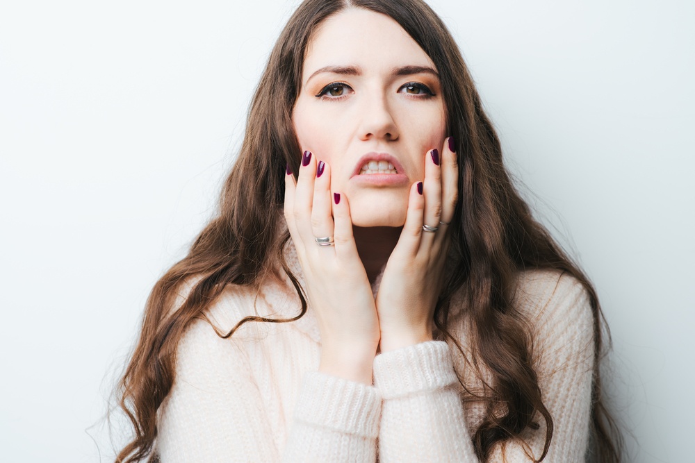 on a white background young girl with long hair tired