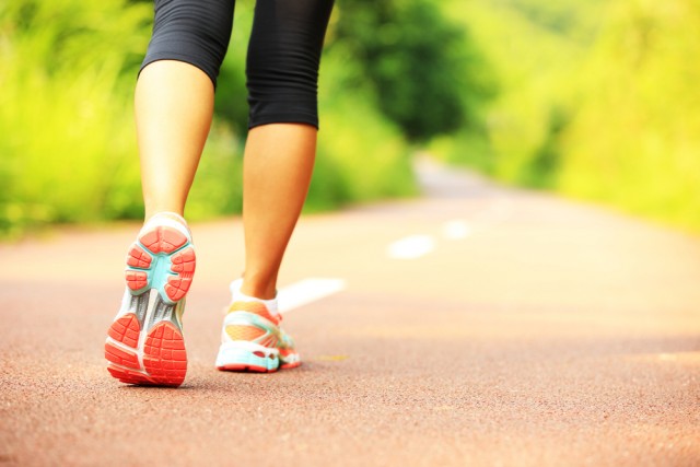 young fitness woman hiker legs  at forest trail