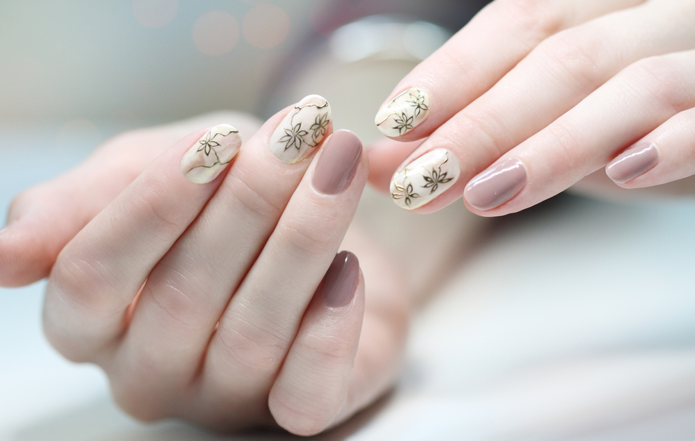 Nail design . Manicure nail paint . beautiful female hand with colorful nail art design manicure