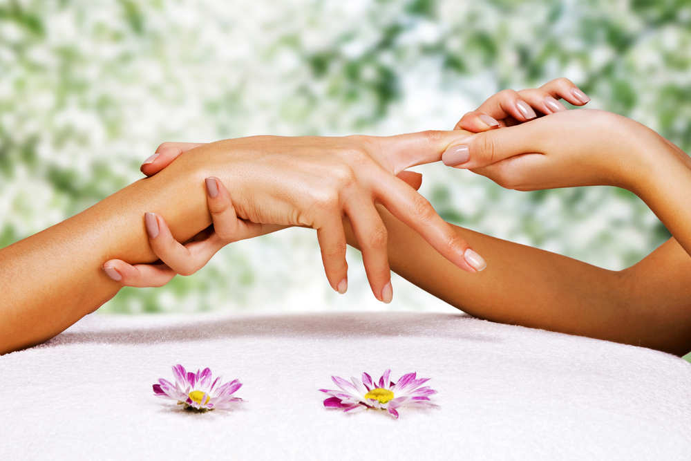Hands massage in the spa salon in the garden