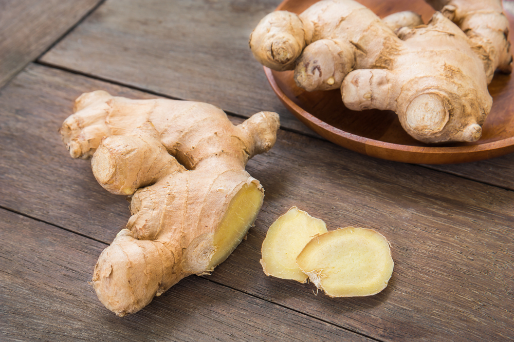 Ginger root sliced on wooden table