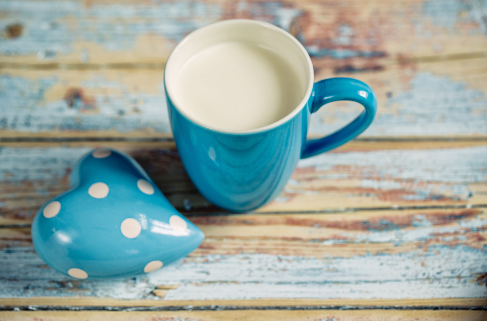 Blue Cup filled with fresh warm Milk